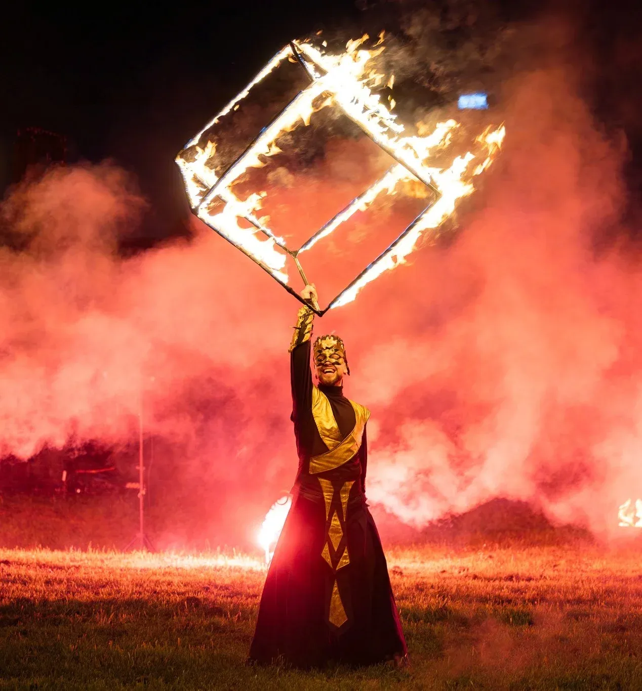 A performer shapes a giant heart of flames during a night show