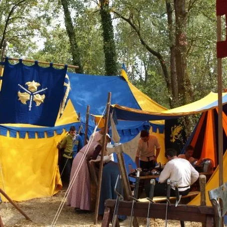 A craftsmen's tent in the forest camp with a griffin banner and table