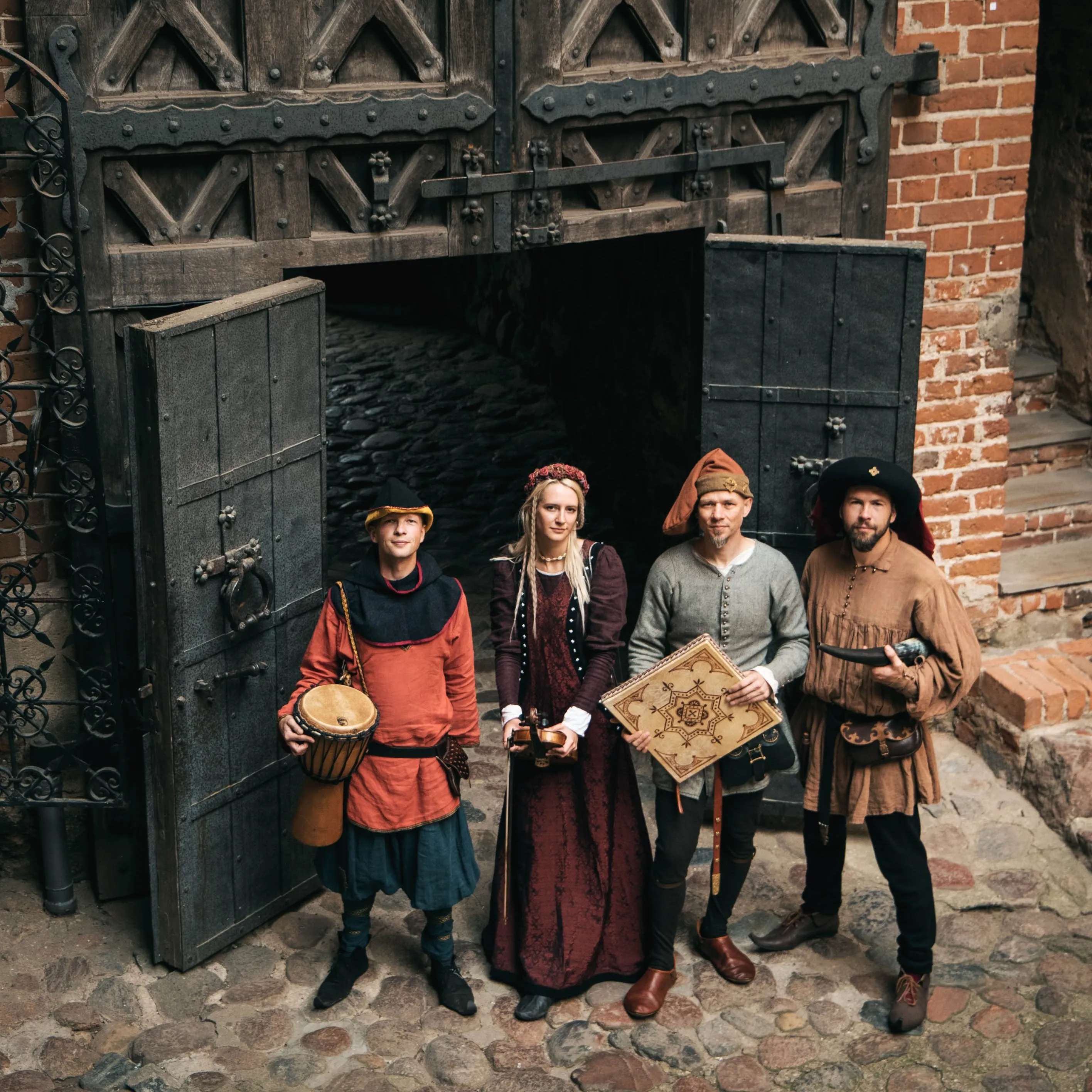 The Ambera group with period instruments at a castle gate
