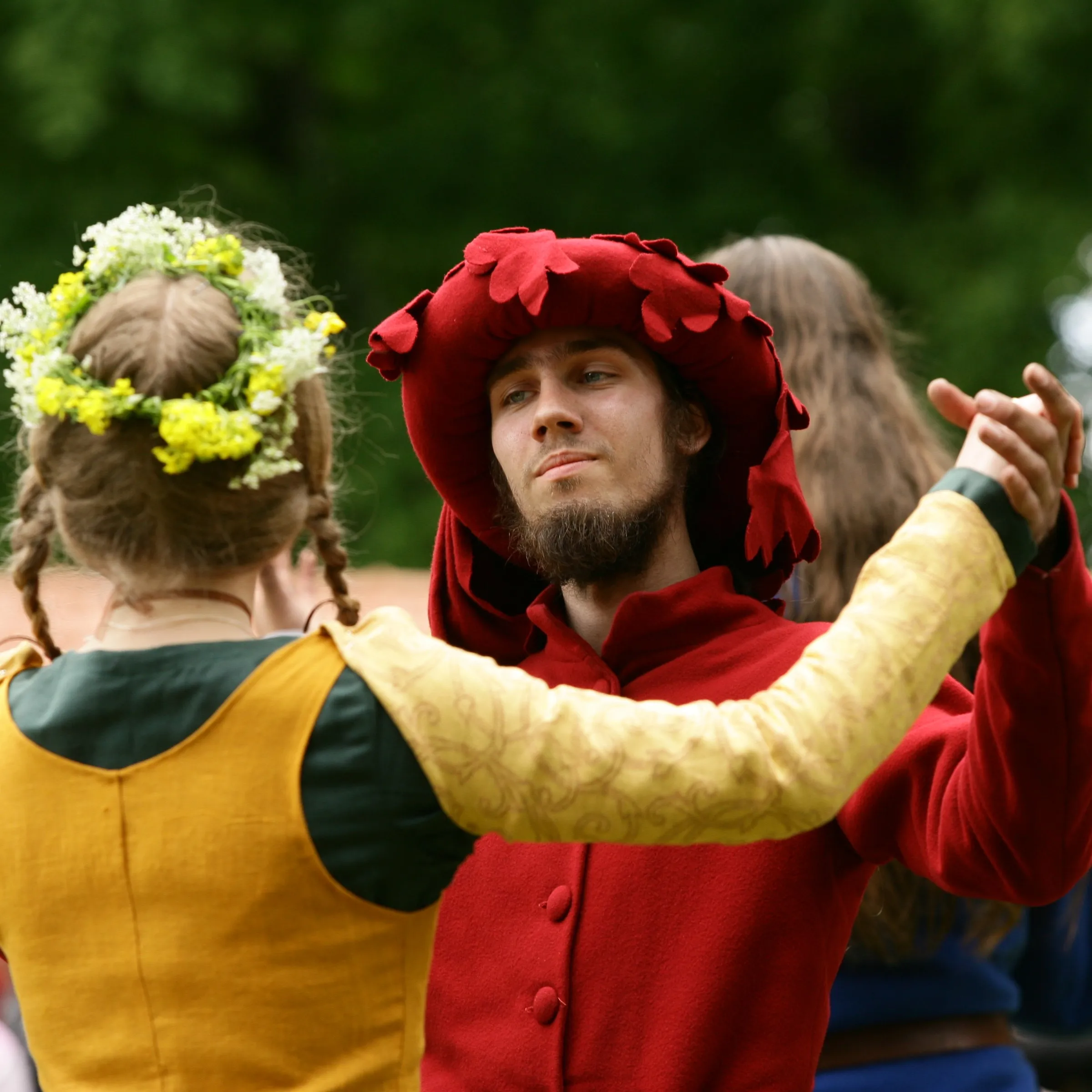 A close-up portrait of a dancing couple, one wearing a flower crown