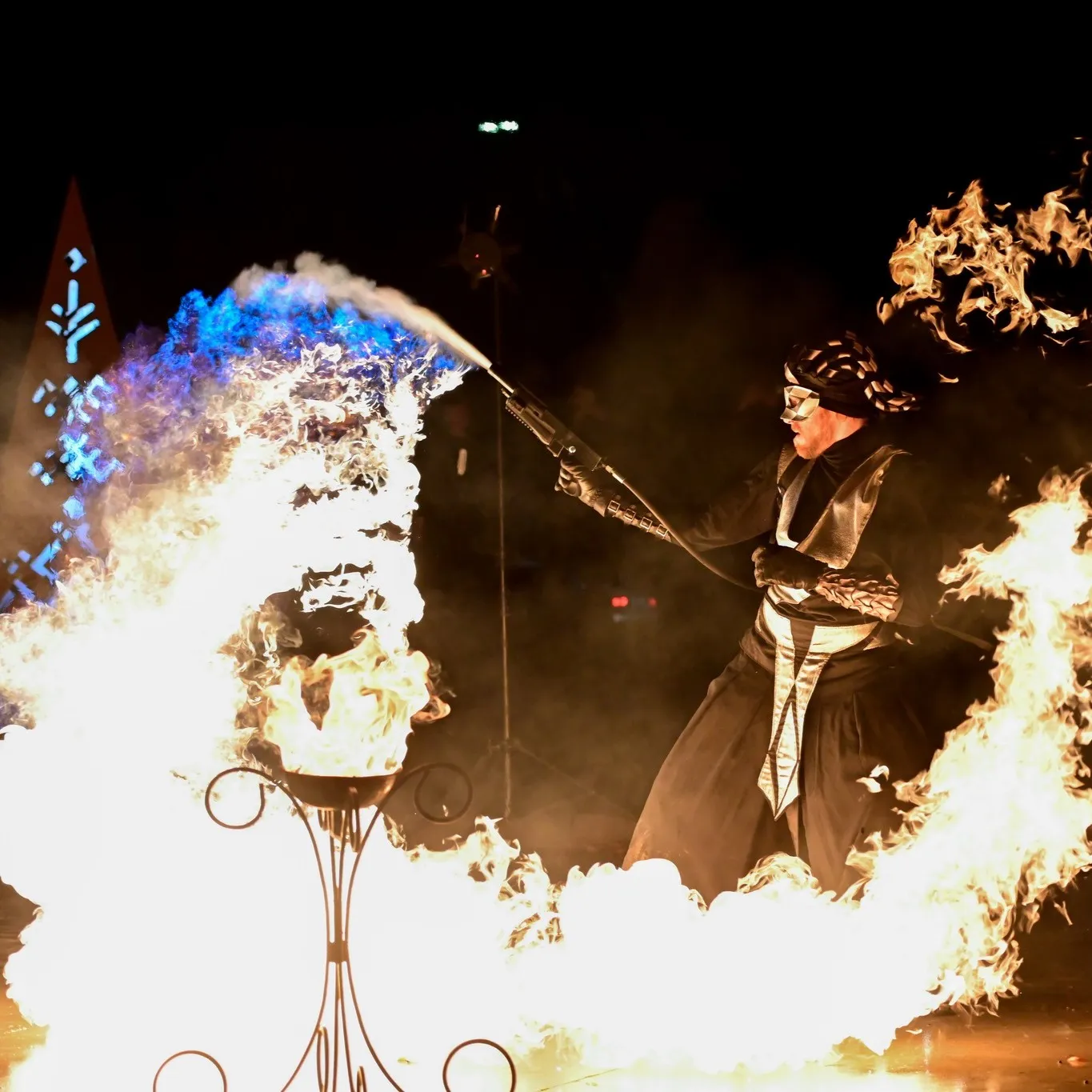 A performer directs a moving fire-spitting device during the show