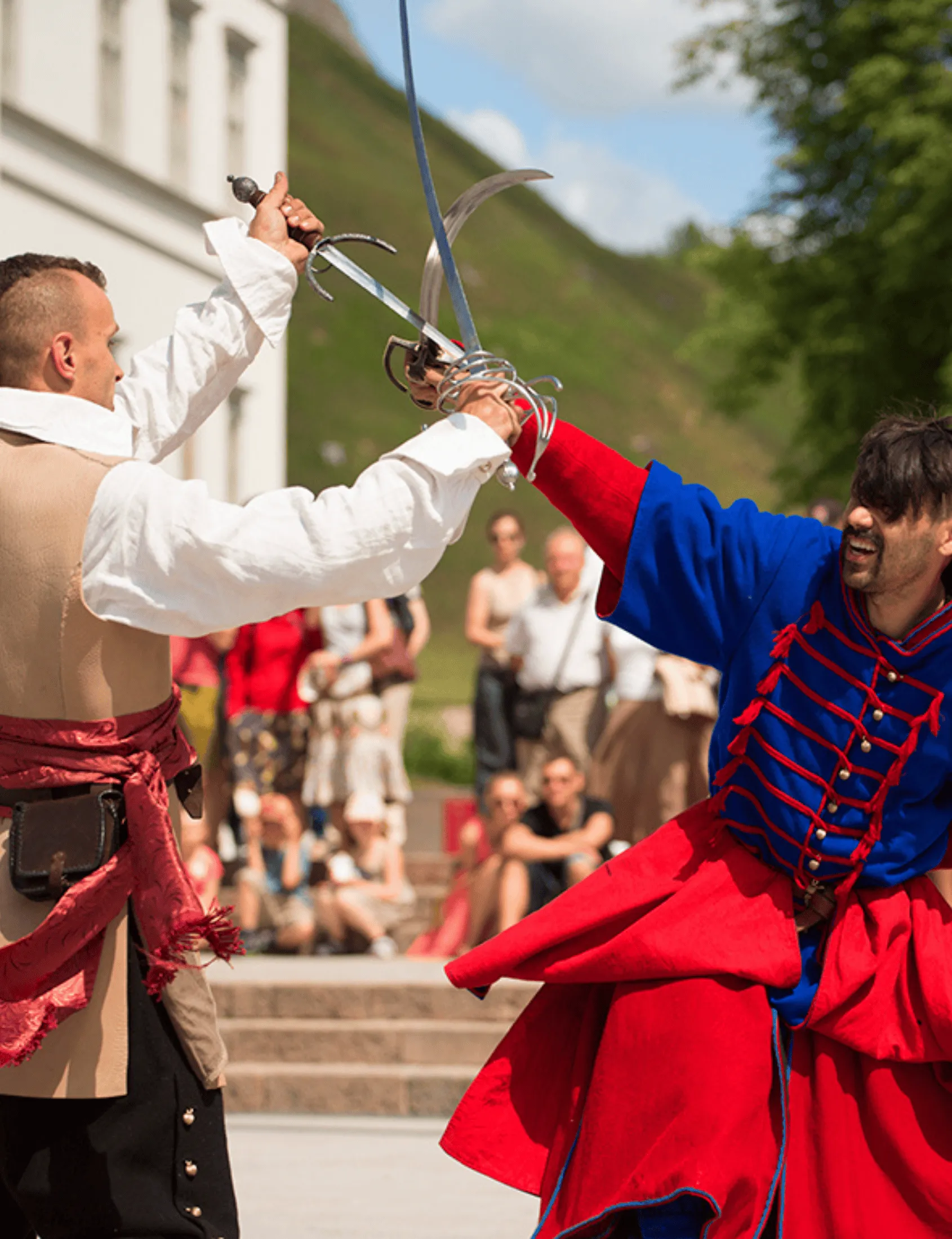 Two noblemen duel with rapiers facing each other outdoors