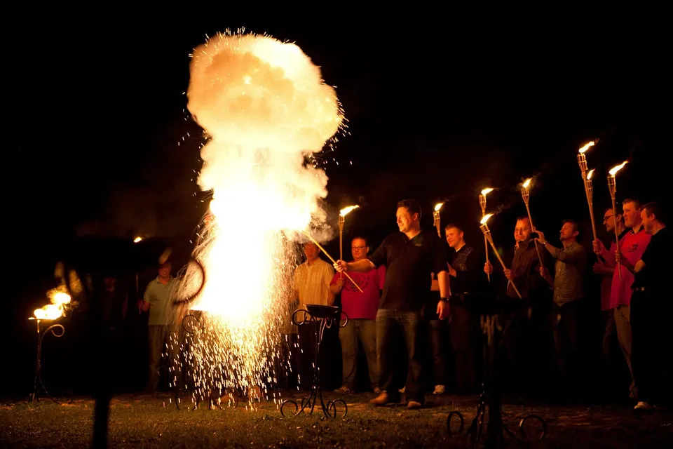 Torch procession and flying sparks at the finale of an evening tour