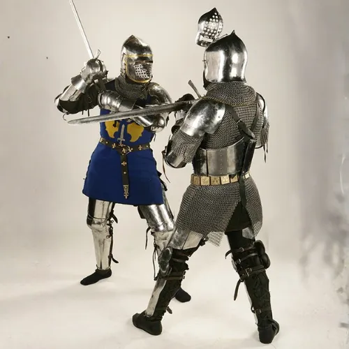 Two knights spar with swords while wearing full steel armor suits