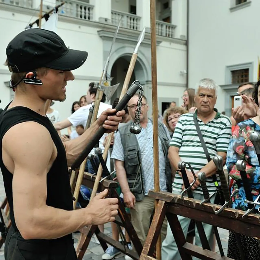 A guide tells the assembled guests about the weapons' history