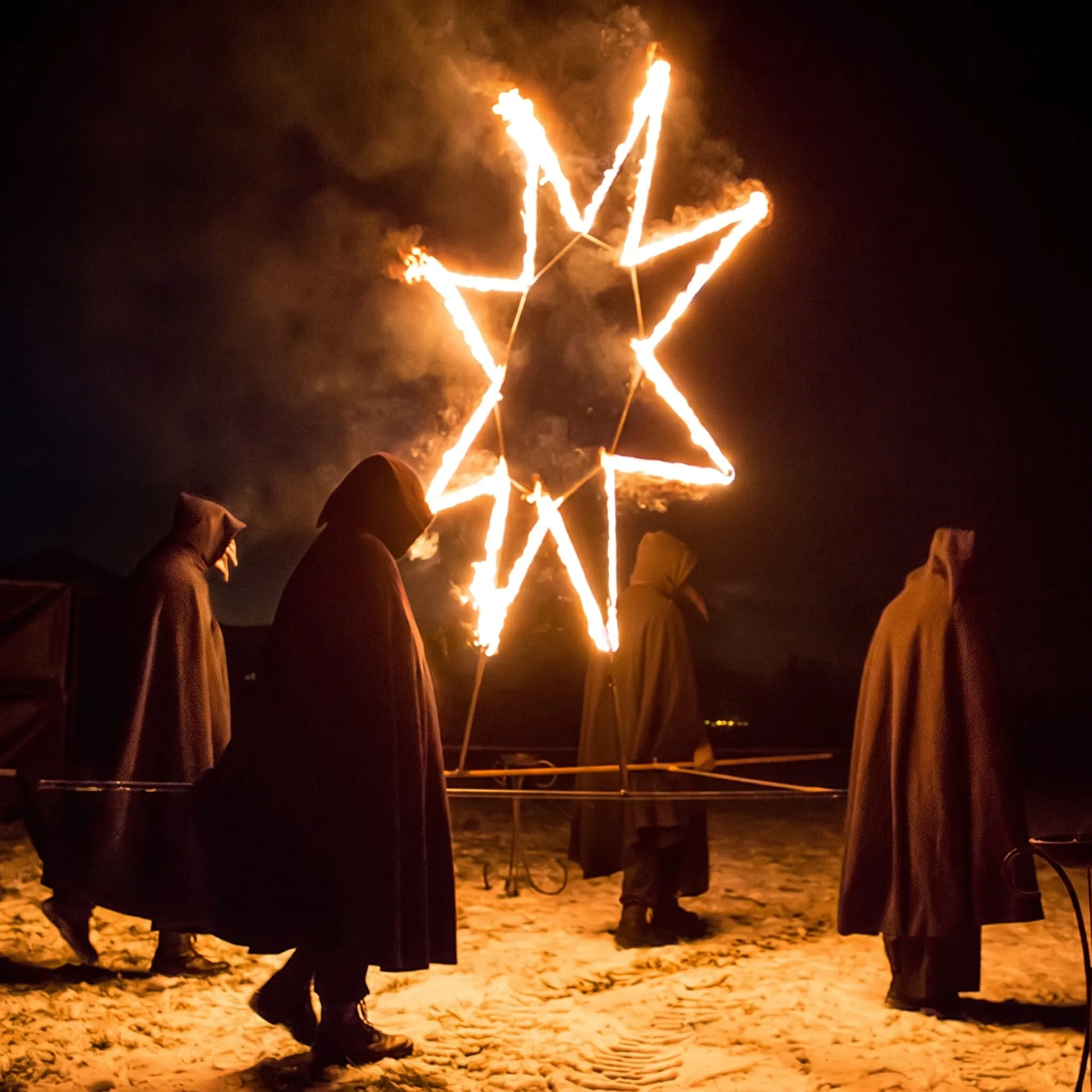 Hooded figures stand before a burning seven-pointed star
