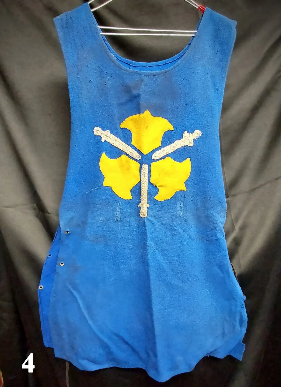Blue heraldic tunic with a yellow coat-of-arms emblem