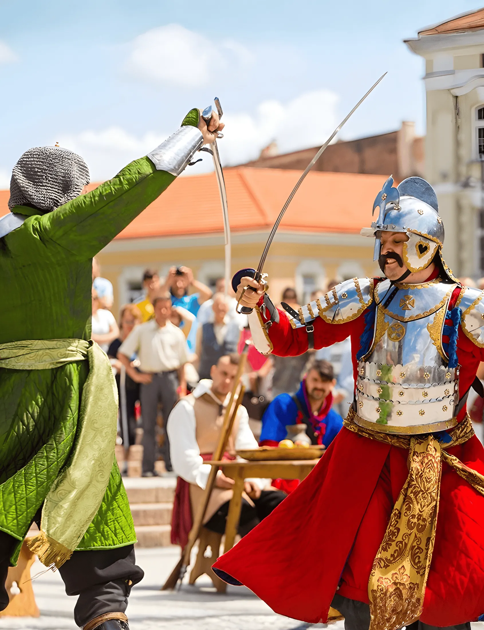 Performers in authentic costumes demonstrate 17th-century combat technique in a town square