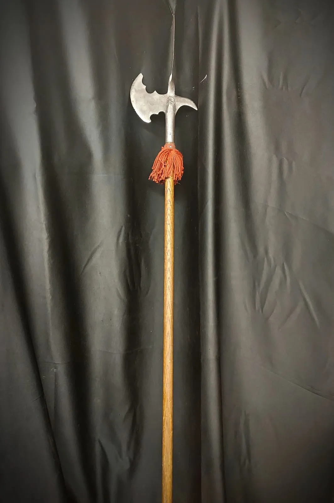 Long-shafted spear with a red tassel below the head