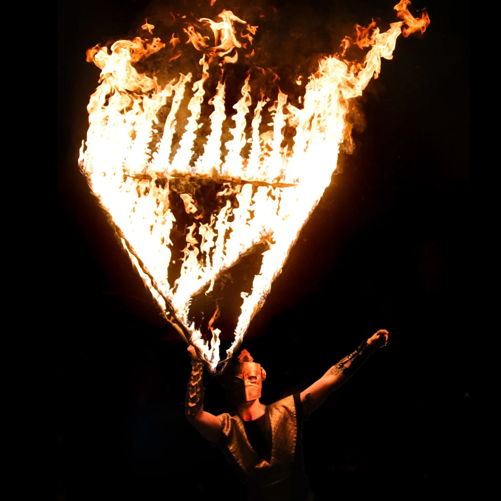 A performer shapes a giant heart of flames during the night show