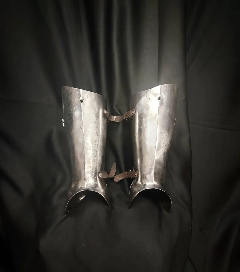 Steel greaves with leather straps