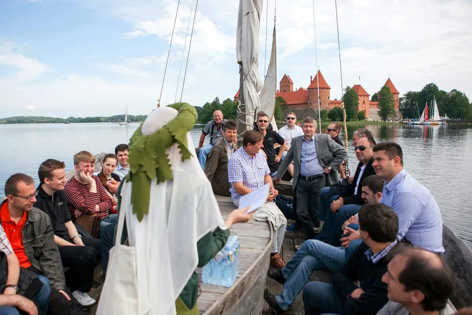 Costumed character telling a story to an excursion group by the lake