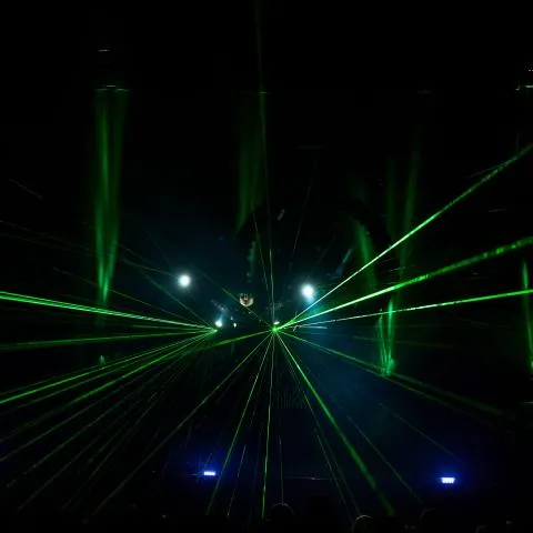 Laser beams on stage form a symmetrical starburst effect