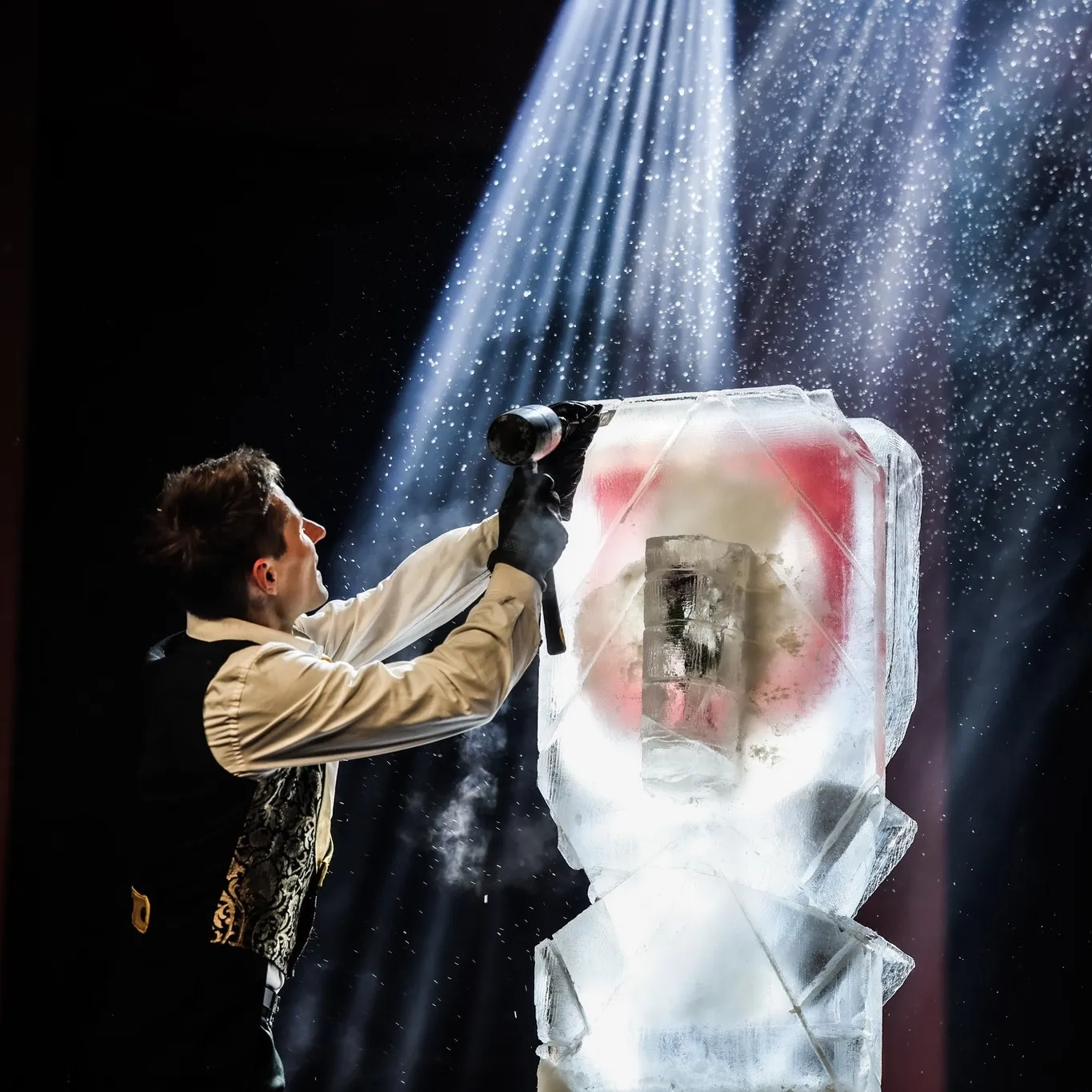 Performer carving an ice sculpture live during the ice show