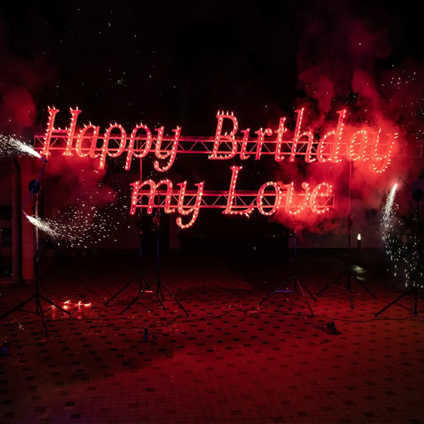 A flaming greeting message with sparks lit up during a celebration
