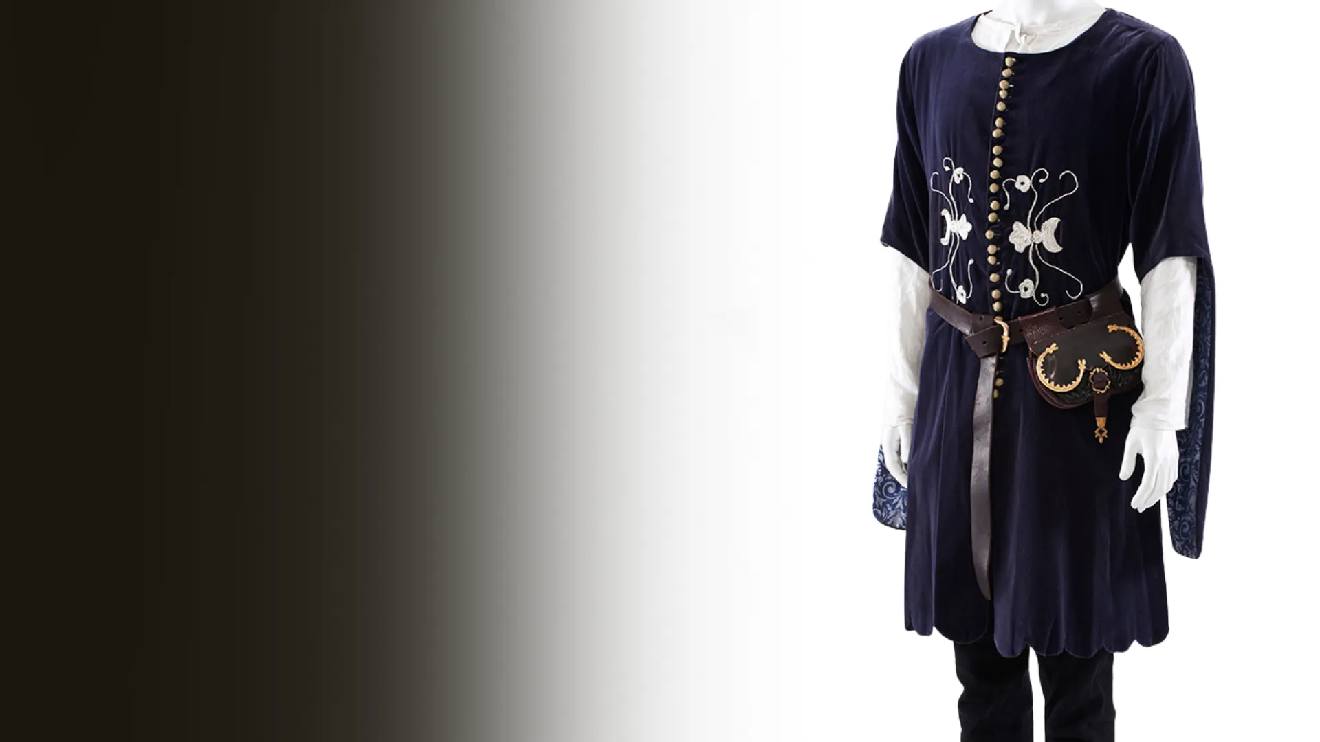 A navy medieval tunic with embroidered patterns and a leather belt