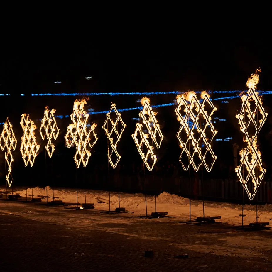 Giant burning sculptures at a night-time town festival