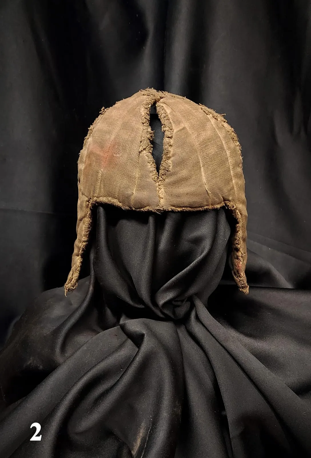 Quilted linen arming cap worn under a knight's helmet