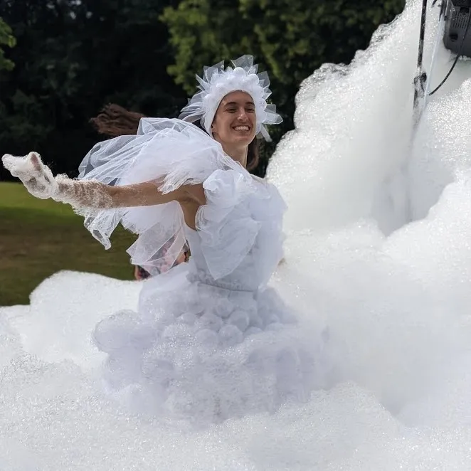 The foam character dances and waves through billowing foam clouds