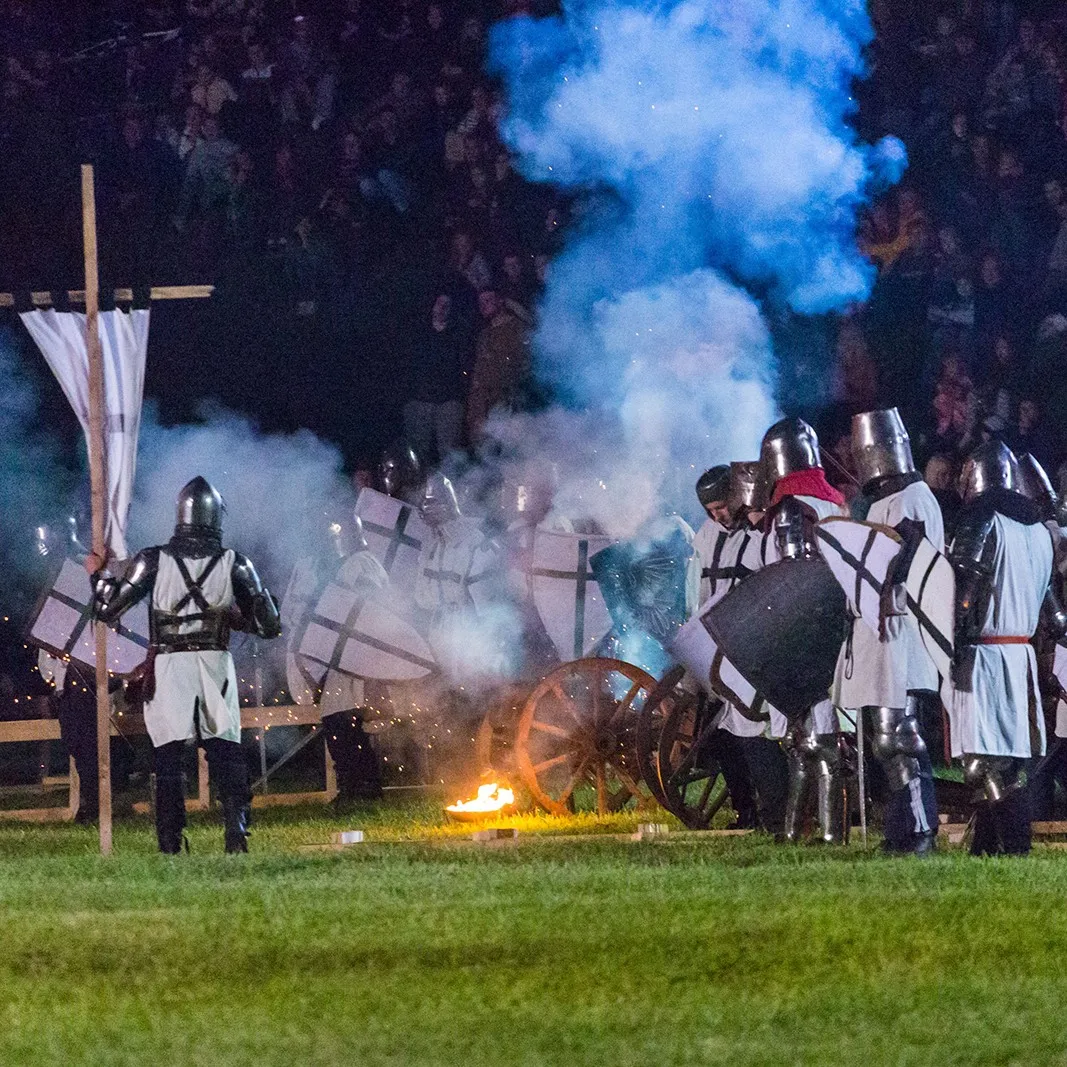 Knights by a cannon with smoke and spark effects for the audience