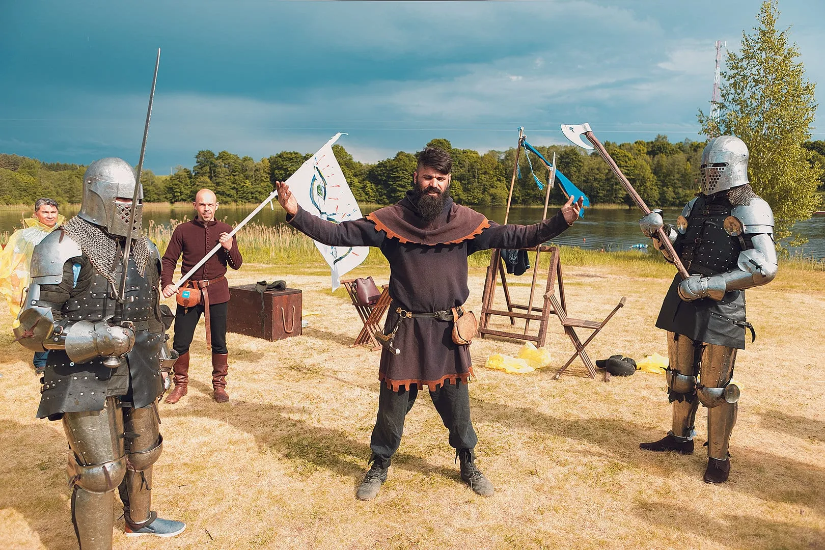 Armoured knights with axes and a banner at a lakeside warfare arena