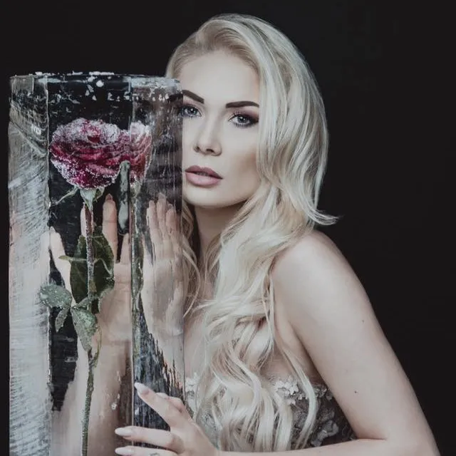 Red rose frozen inside a clear ice block as show decor