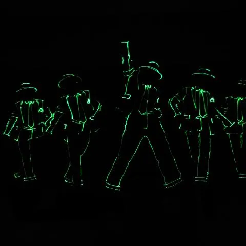 A line of performers in glowing LED costumes on stage