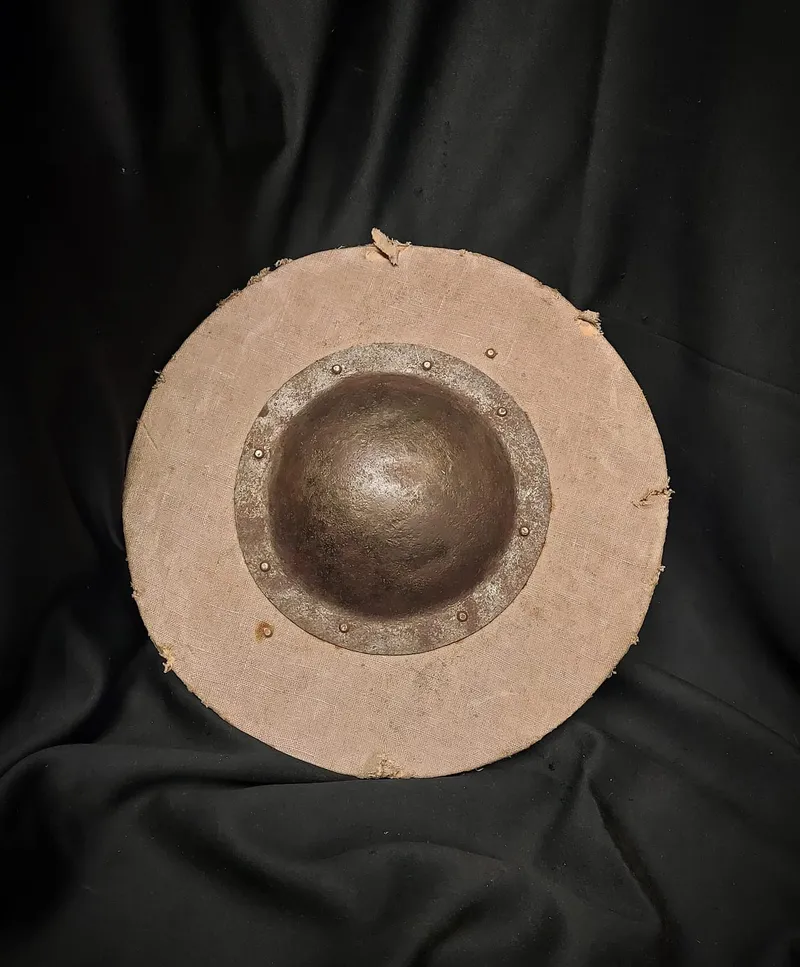 Round wooden shield with a central metal boss