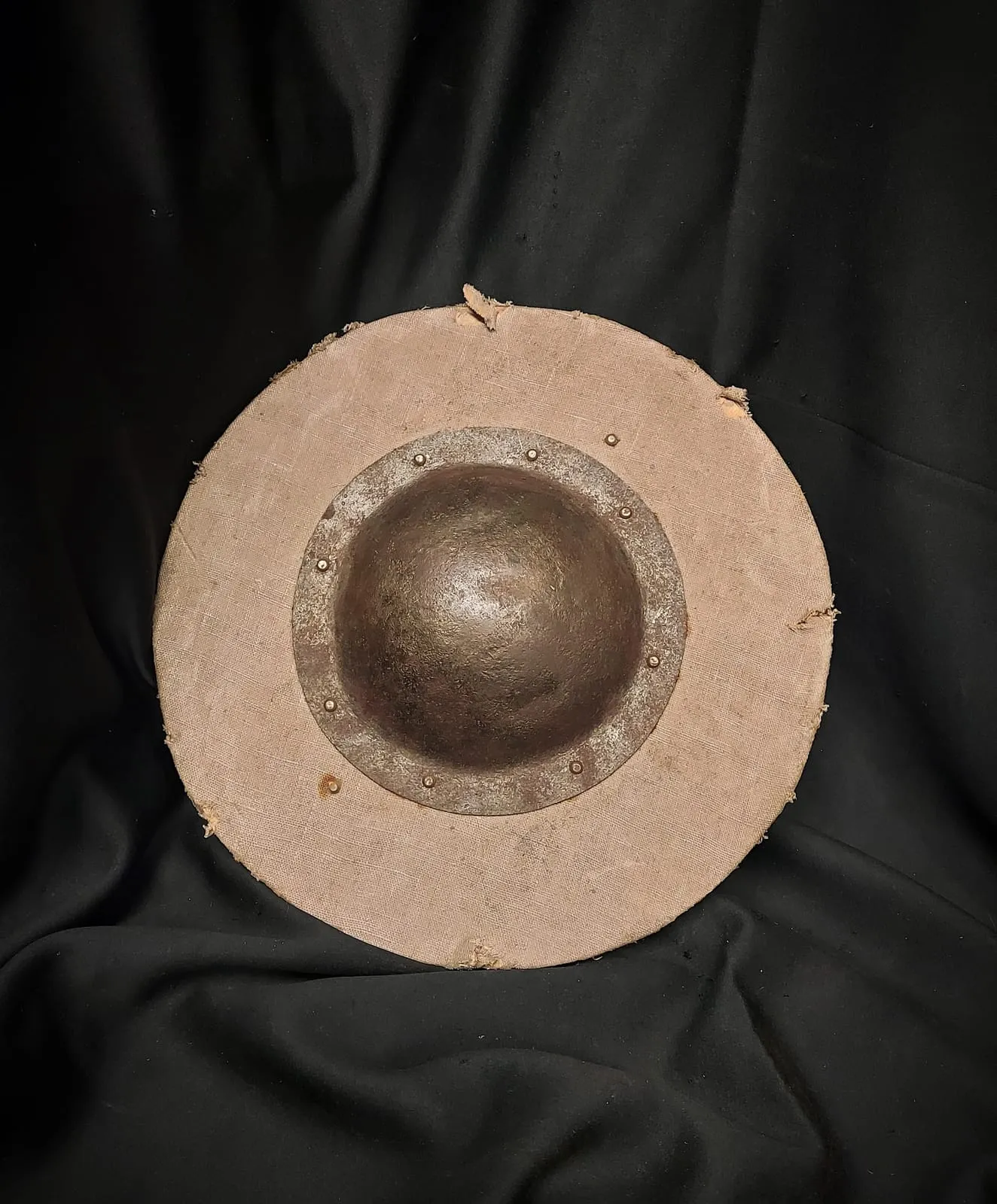 Round wooden shield with a central metal boss