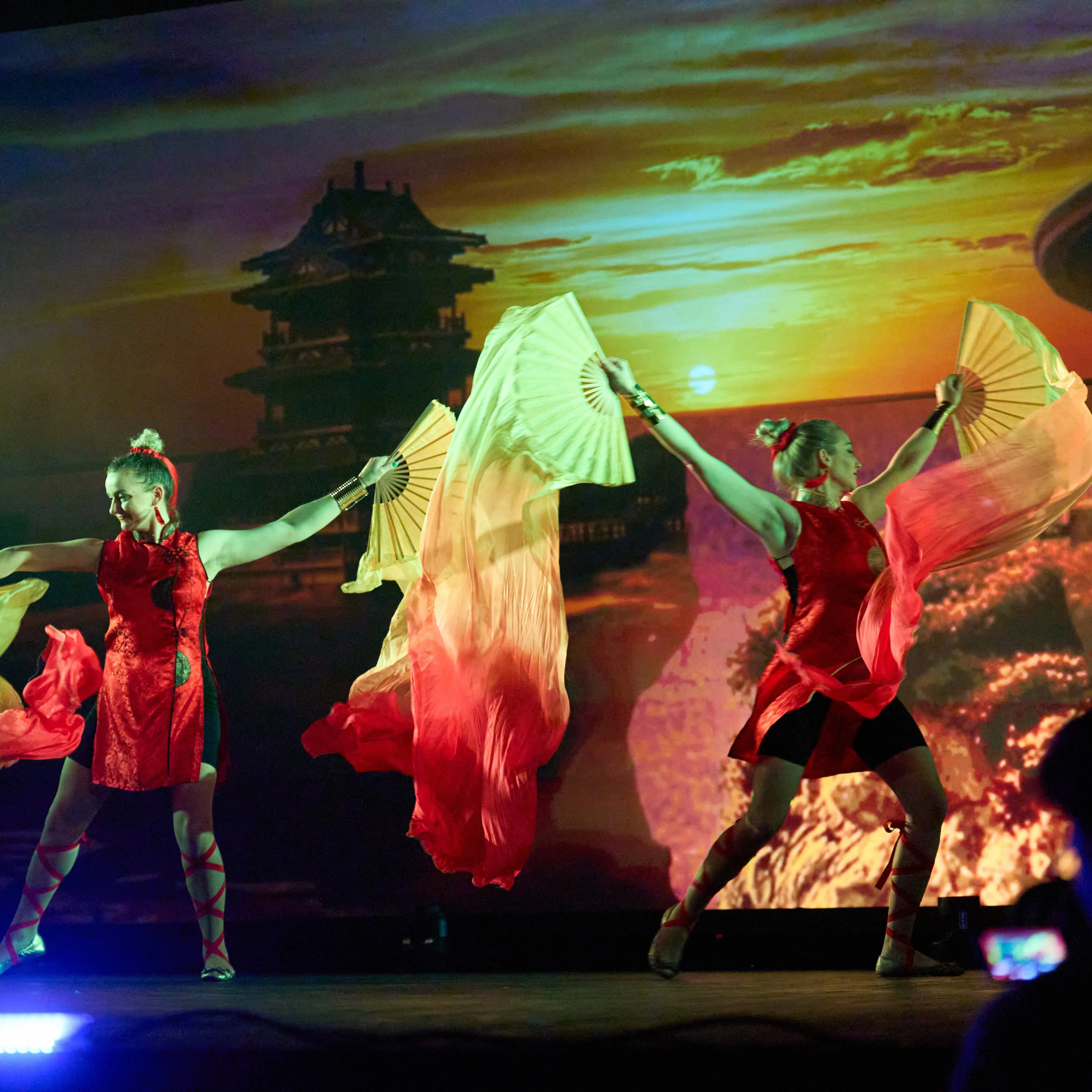 Dancers perform a Chinese-style routine waving long silk fan streamers
