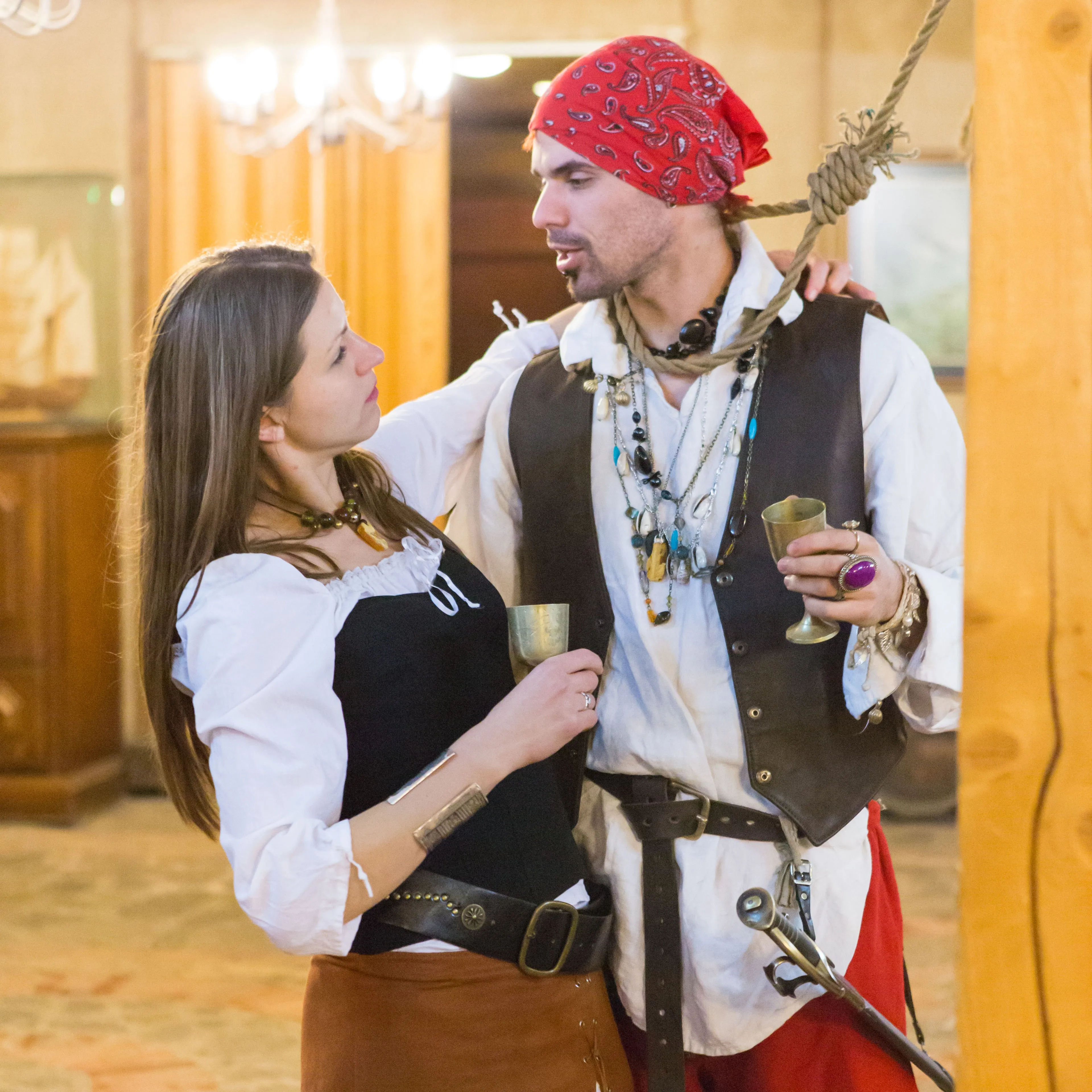 A pair of pirate characters holding goblets during the party scene