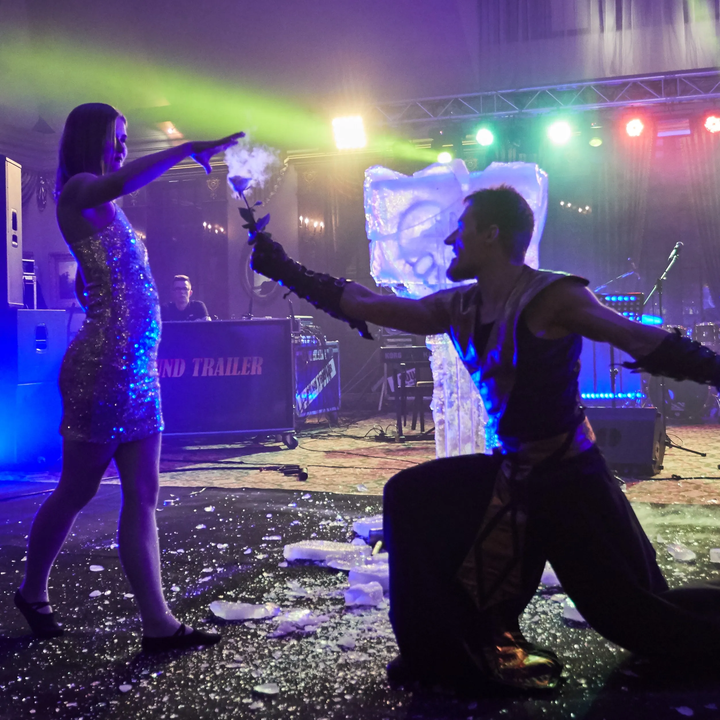Performers exchange a flaming rose prop during the ice and fire show