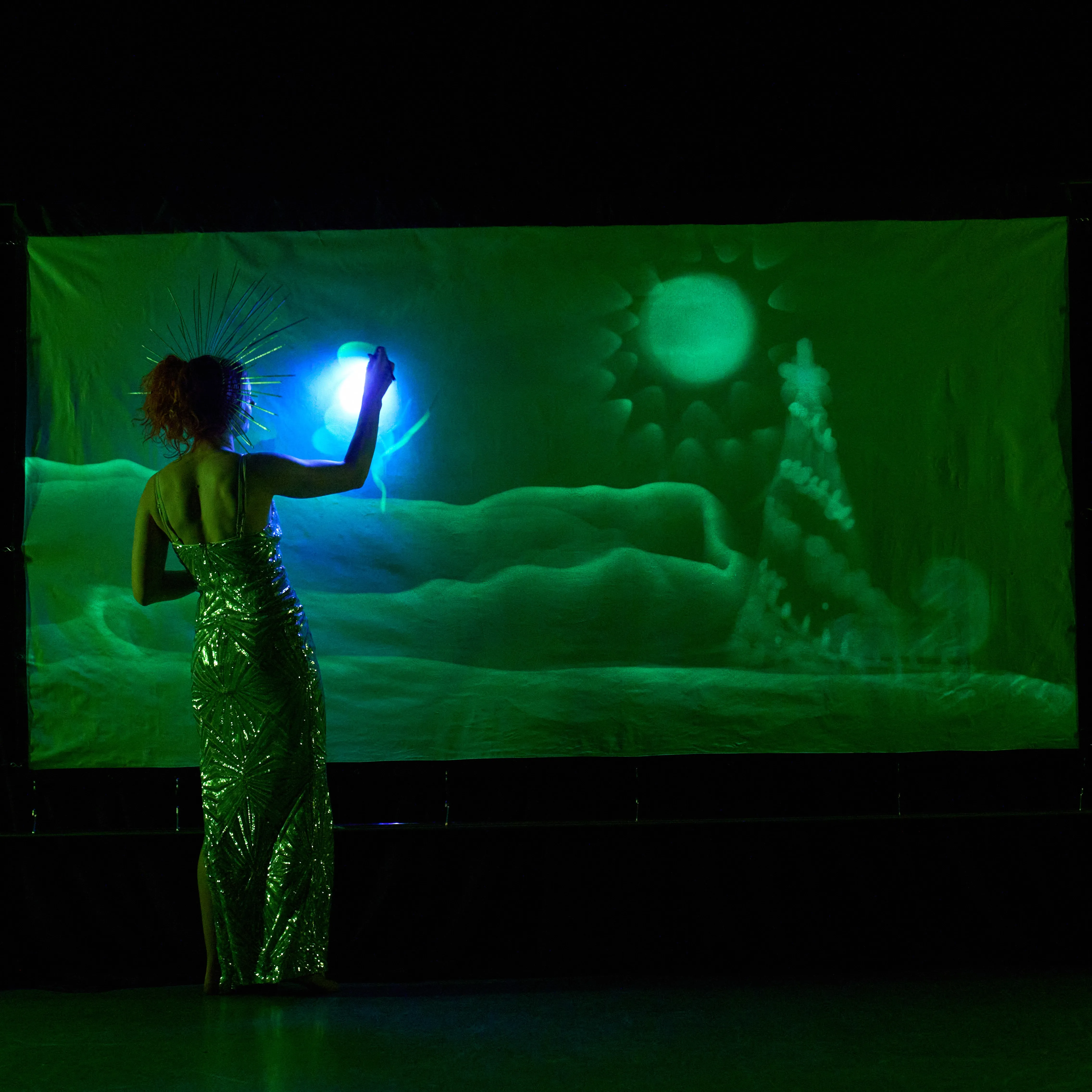 Performer beside a glowing "Manager of the Year" inscription for an awards evening