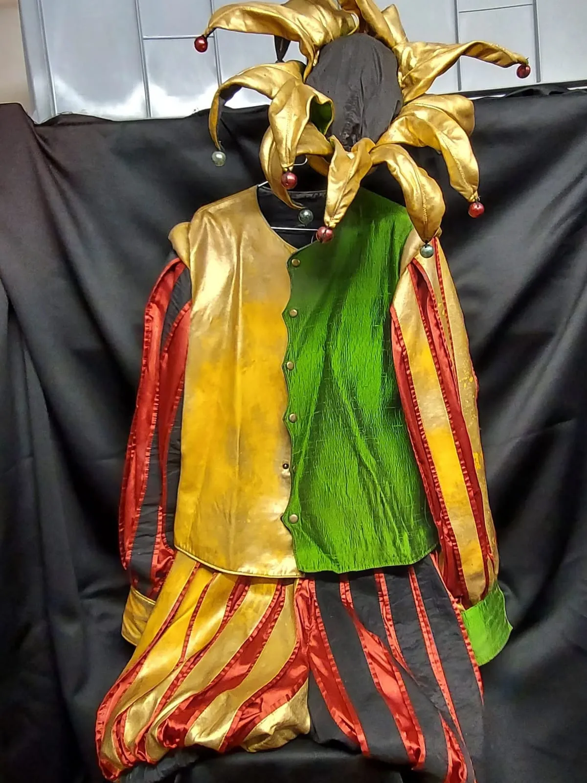 Colourful medieval men's costume in yellow and green